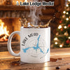 White mug with Lake Mead, Arizona compass design near a fireplace and Christmas tree.
