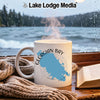 White mug with Georgian Bay map, steam rising, by a rainy window.
