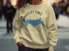 Light yellow sweatshirt with Rangeley Lake map graphic and compass on front.