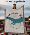 Harlan County Lake Nebraska map on woven blanket held by a man.