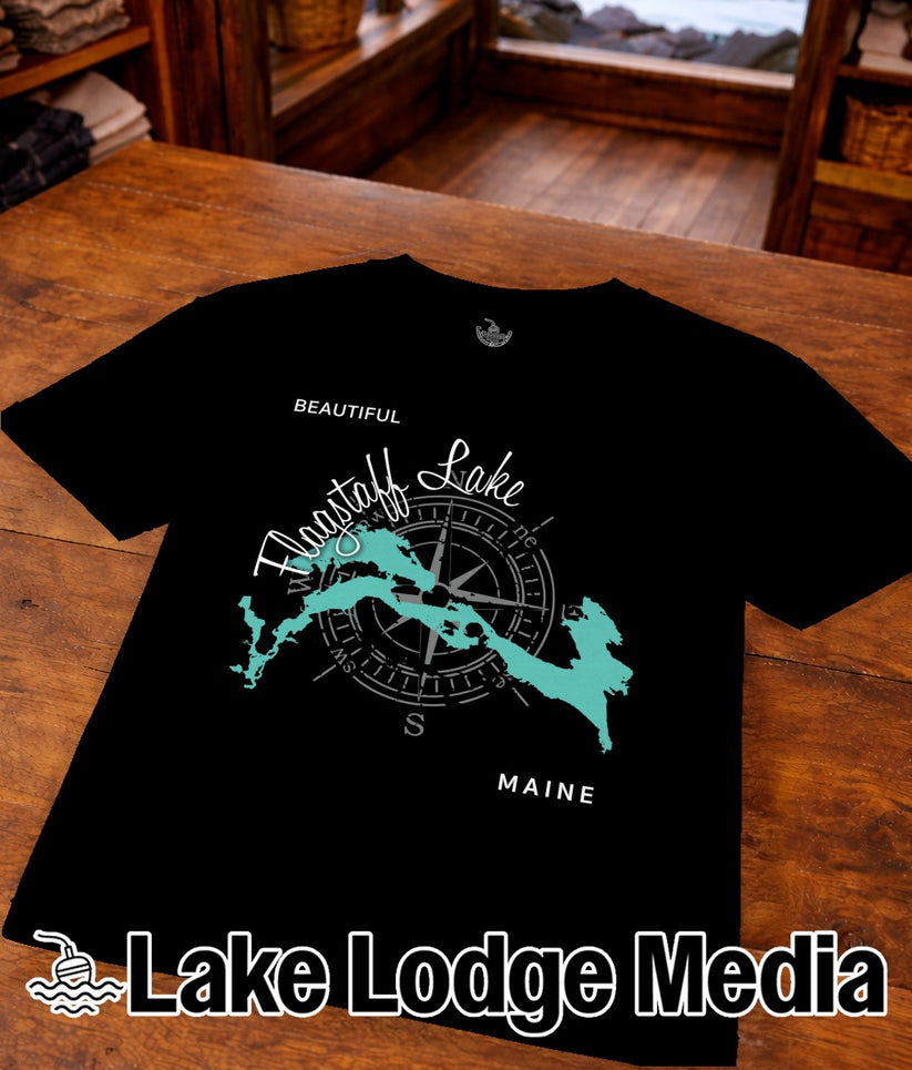 Black t-shirt with a compass rose and a turquoise outline of Moosehead Lake, Maine.