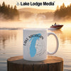 White mug with "Lake Michigan" and compass design on a lake background.