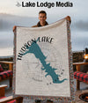 Man holding Hudson Lake, Oklahoma map blanket with compass rose design.