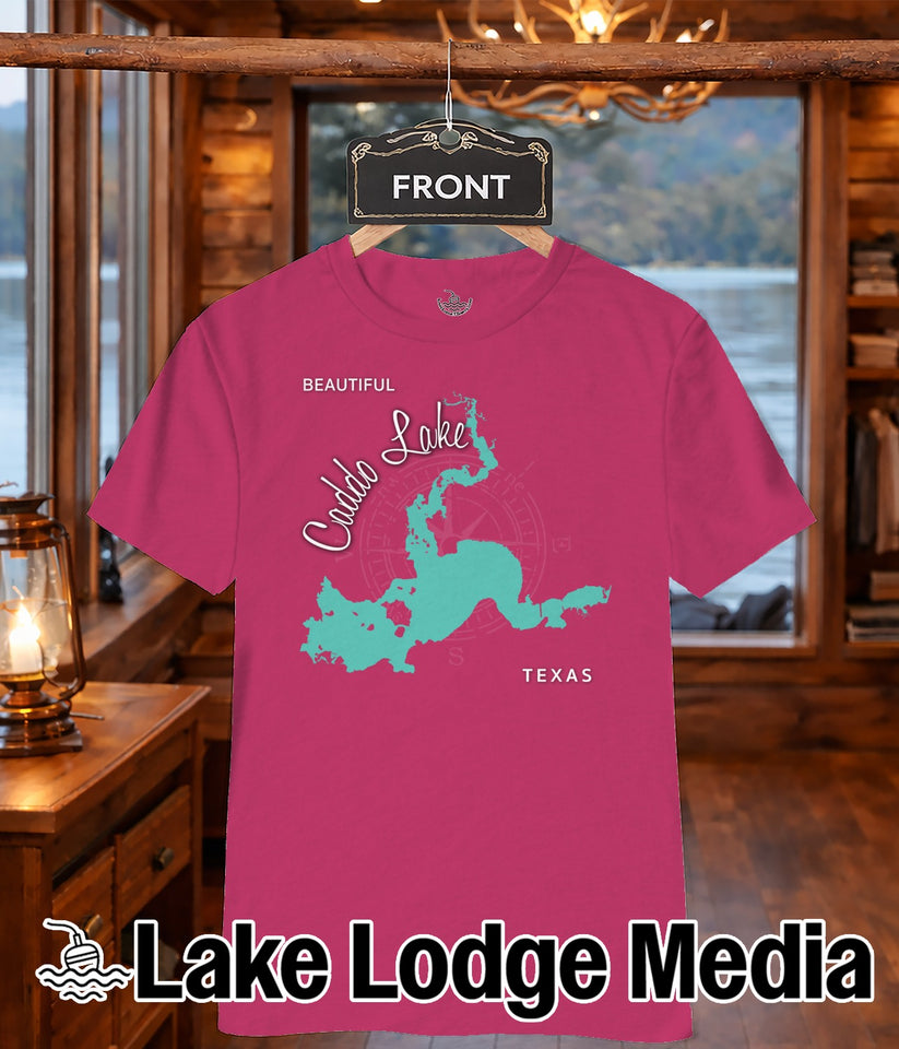 Pink t-shirt with turquoise Caddo Lake graphic and "Lake Lodge Media" logo.