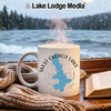 White mug with West Okoboji Lake map, compass, and steam on a cozy windowsill.