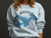 Light blue sweatshirt with "Lake Arrowhead California" and compass map graphic.