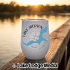 White insulated stemless tumbler with Lake Jackson Georgia text and a blue lake map graphic on a wooden dock at sunset.