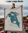 Man holding Lake Kissimmee Florida map blanket with compass rose and fringed edges.