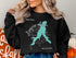 Black sweatshirt with teal Longview Lake map and compass graphic.