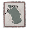 Woven throw with Lake George outline and compass rose, "Lake George Florida" text.