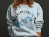 Light blue sweatshirt with Douglas Lake map and compass design.