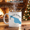 White mug with Catalina Island map graphic, steaming coffee, fireplace and Christmas tree background.