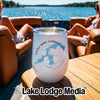 A white insulated wine tumbler with a map and text of Little Saint Germain Lake sits on a boat table.