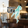 "Beleus Life" text sticker with teal abstract map shape on a window.