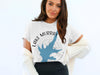 White t-shirt with blue Lake Murray map graphic and compass on woman.