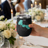 Black tumbler with Forest Lake Minnesota map and compass graphic held at a table.