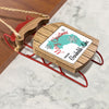 Wooden sled ornament with "Merry Christmas FROM Garibaldi Lake" text and snowflakes.