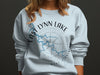 Light blue sweatshirt with "East Lynn Lake West Virginia" compass design.