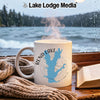 White mug with Rend Lake map graphic and steam, placed by a window with rain.