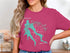 Turquoise Willow Springs Lake logo on pink t-shirt.