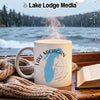 White mug with Lake Michigan map and compass, by a window and book.