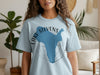Light blue t-shirt with blue map of Lake Stevens, Washington and compass graphic.