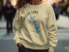 Cream crewneck sweatshirt with Falcon Lake Texas map and compass design.