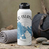 White water bottle with map and compass design, next to gym bag.