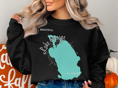 Black sweatshirt with turquoise Lake George, Florida map and compass graphic.