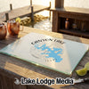 Glass cutting board featuring a map of Canyon Lake, Texas, resting on an outdoor wooden bar.