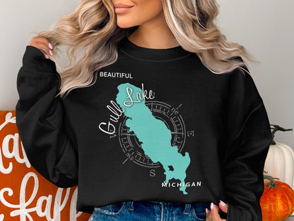 Black sweatshirt featuring a teal outline of Gull Lake, Michigan with compass rose.