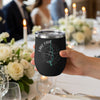 Black tumbler with "Lake Oahe" and compass design held by hand.