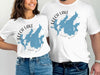 White t-shirts with blue outline maps of Leech Lake, Minnesota.