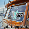 Burton Life logo on a boat window, with Lake Lodge Media text below.