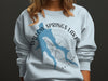 Light blue sweatshirt with Willow Springs Lake Arizona design and compass rose.