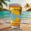 Glass of beer with Marco Island map and compass, on a beach.