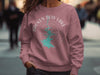 Dusty rose crewneck sweatshirt with Broken Bow Lake Oklahoma compass graphic.