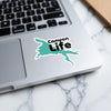 Turquoise "Canyon Life" sticker on a silver laptop keyboard.