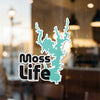Turquoise lake outline sticker with "Moss Life" text on glass.