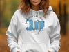 White hoodie with a blue map outline and text "Manasquan Reservoir New Jersey".