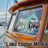 Turquoise Jacomo Life sticker on a boat window, "Lake Lodge Media" text below.