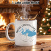White mug with "Choke Canyon Lake Texas" design, steaming coffee splashing.