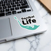 Sanibel Life sticker on a laptop keyboard.