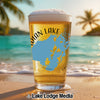 Glass of beer with Indian Lake map design on a beach with palm trees.