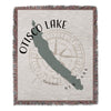 Woven blanket with Otisco Lake map, compass rose, and "New York" text.