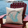 Calaveras Lake Texas map compass pillow on a red Adirondack chair near water.