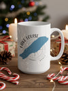 White mug with Lake Louise map graphic and compass design, surrounded by holiday decorations.