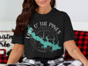 Black t-shirt with green Lake O' the Pines map and compass design.