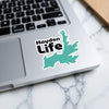 "Hayden Life" sticker with lake outline on a laptop keyboard.