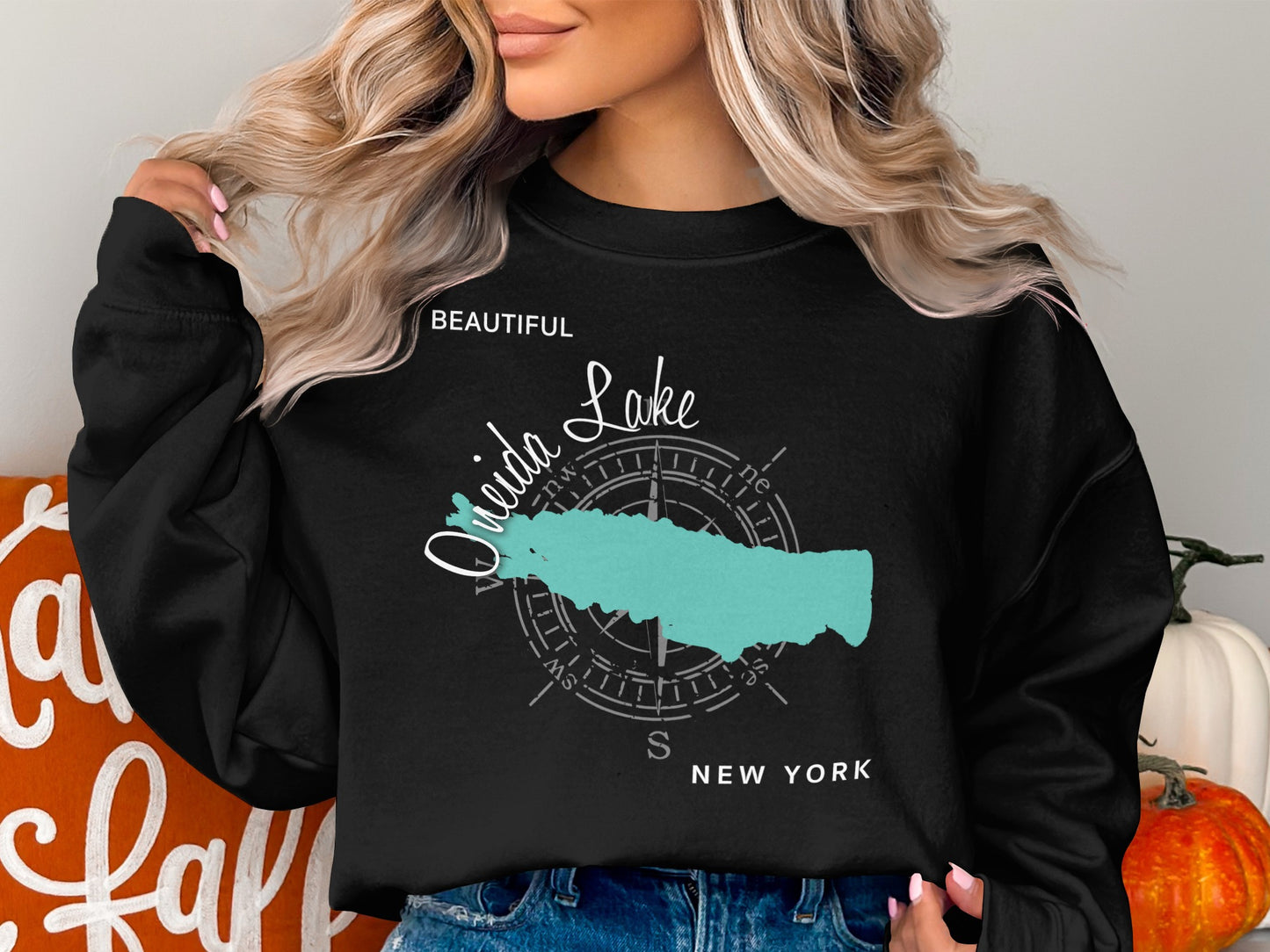 Black sweatshirt with a teal outline of Oneida Lake and a compass rose.